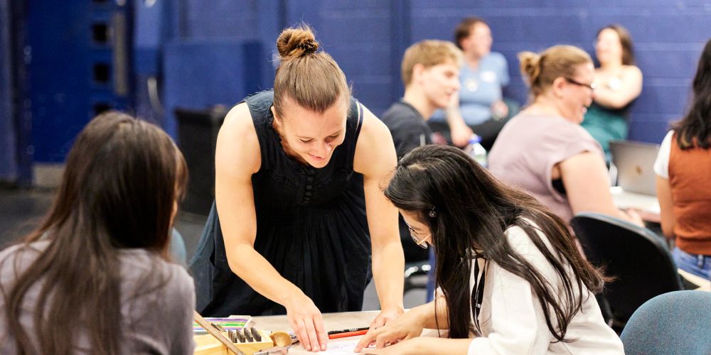 Katherine James demonstrates an activity to a student