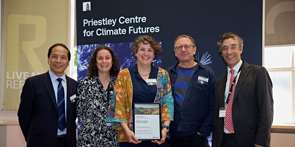 5 people stand to receive an award at the Priestley Centre for Climate Futures launch event.