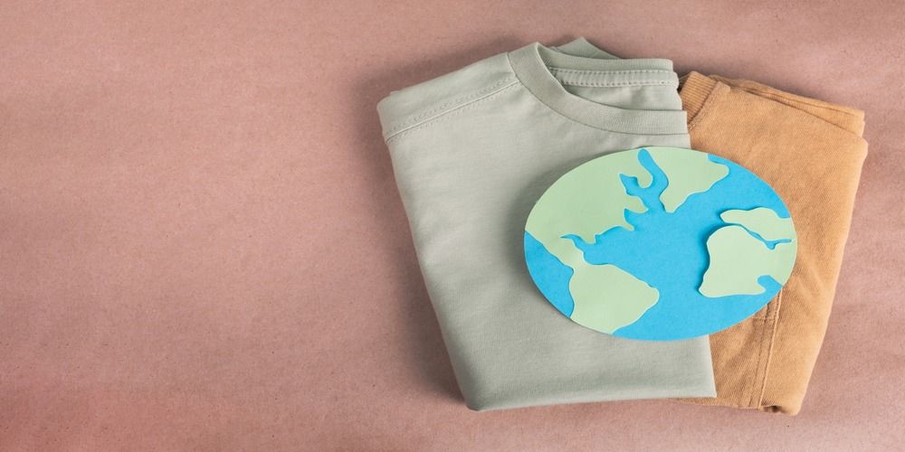 Sustainably made t-shirts overlaid with a cut-out of the globe to show they are planet-friendly