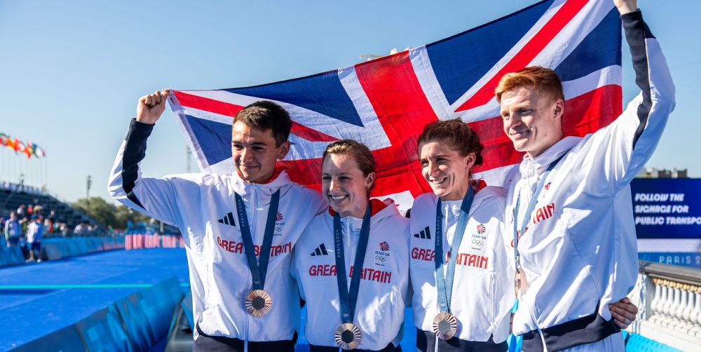 Sam Dickinson and team mates celebrate their medals with the Union Jack flag