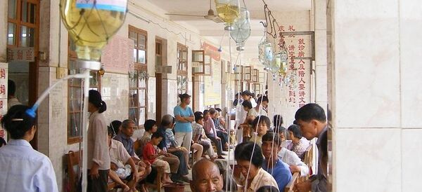 Picture shows people in a hospital in rural China attached to antibiotic drips