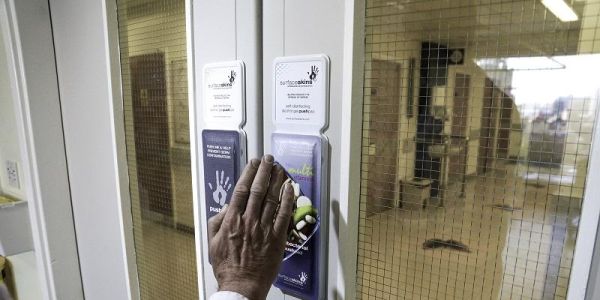 Picture shows a hand opening a door