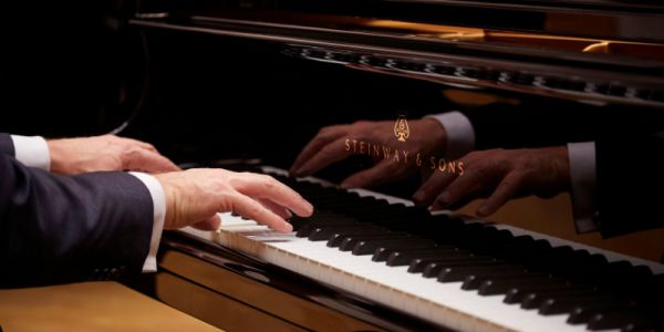 A pianist plays a Steinway piano