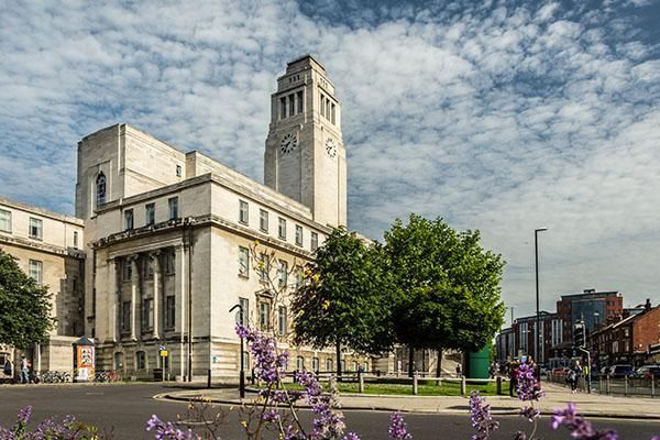 Parkinson Building in spring surrounded by blue skies and purple flower