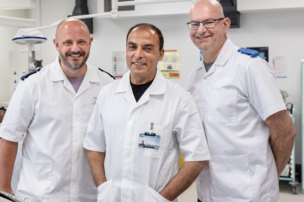 Three nursing associate apprentices in scrubs