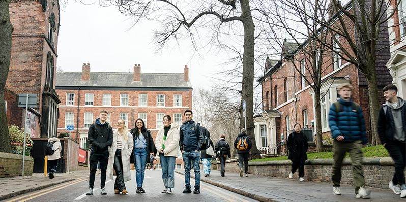 A group of students walking near the Business School.