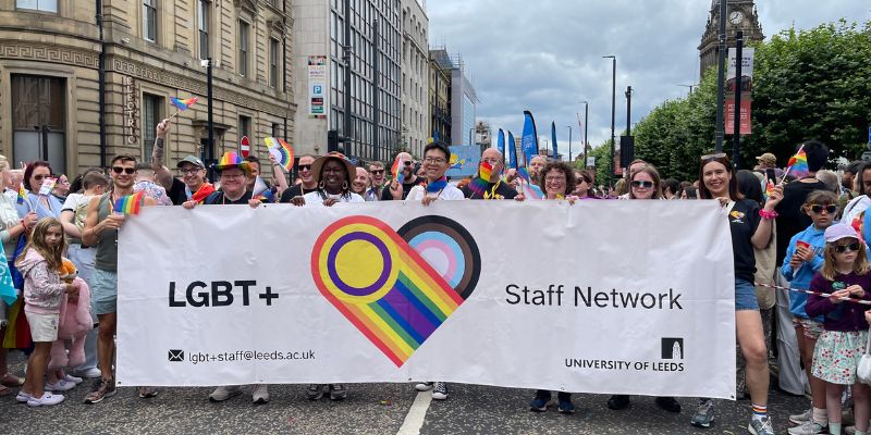 Members of the LGBT+ Staff Network holding a banner, marching at Pride in the City Centre