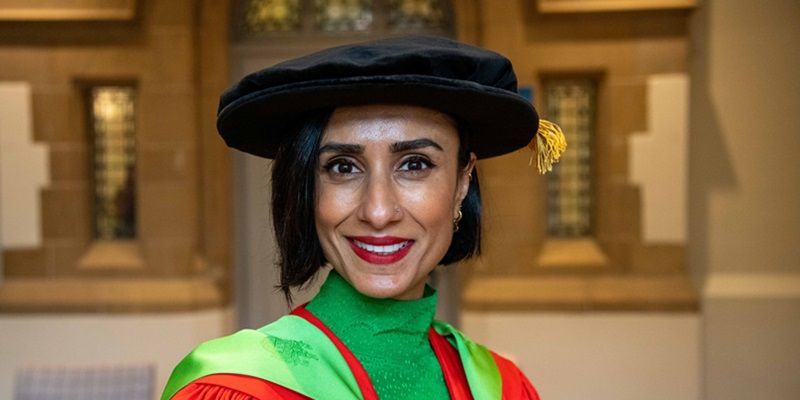 Anita Rani wearing a graduation cap and gown.