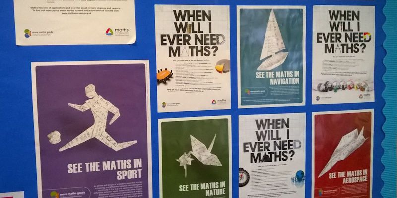 A noticeboard with posters about Maths. Visible text on posters includes 'When will I ever need Maths?' and 'See the Maths in sport/nature/navigation/aerospace'.
