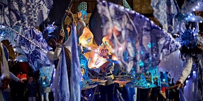 A group of performers at Leeds Light Night, dressed in bright and dynamic costumes.