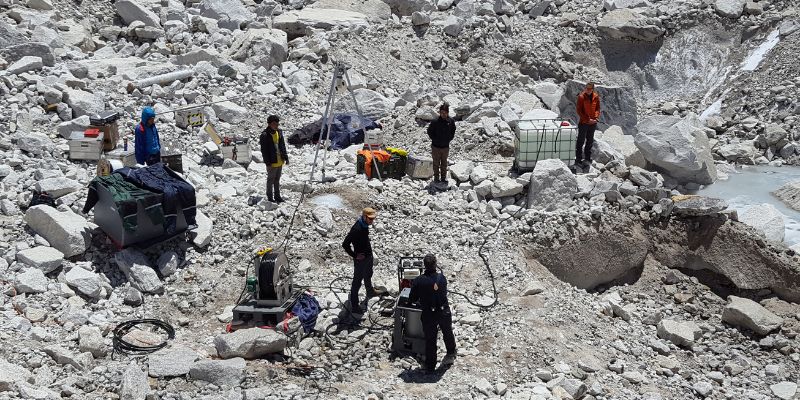 A group of researchers with drilling equipment on Mount Everest