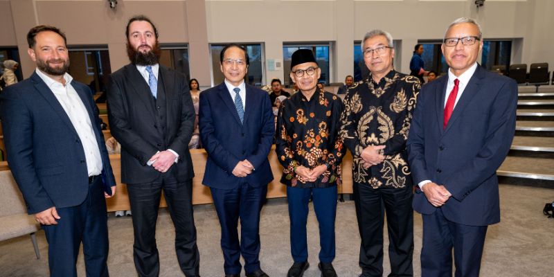 The ambassador and delegation all smiling at the camera