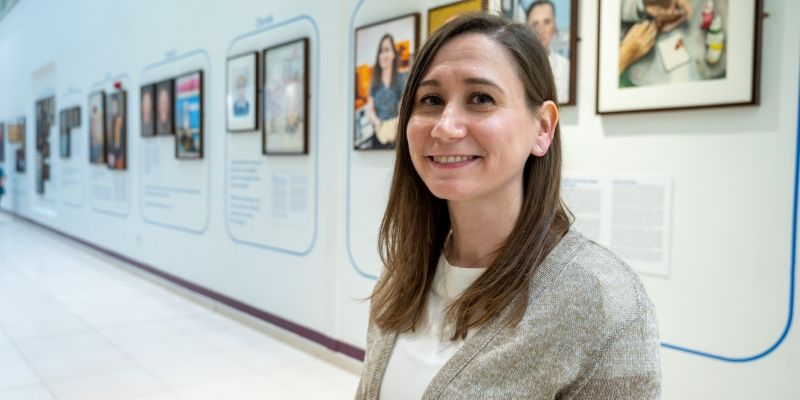 Dr Rachael Jablonski in front of her portrait displayed in the Bexley Wing at St James' University Hospital