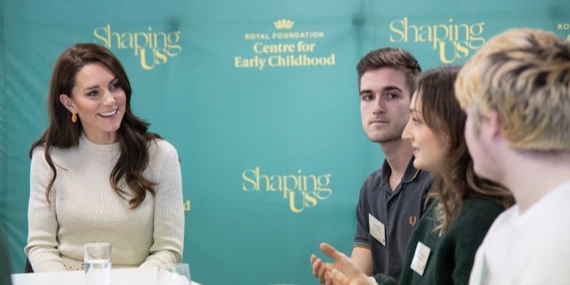 HRH The Princess of Wales speaking to three students around a table