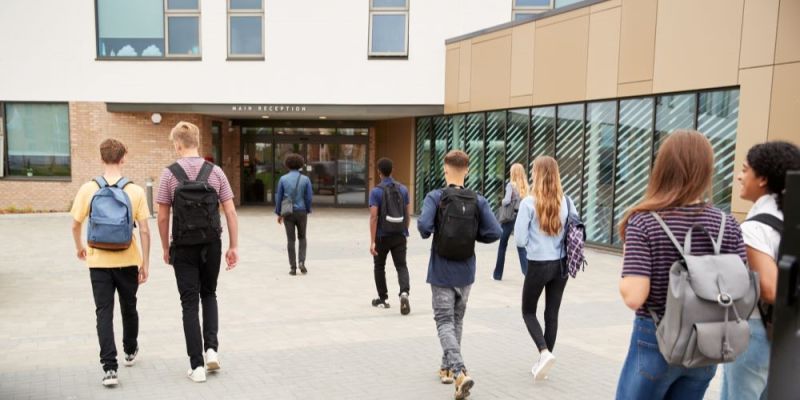 A group of students walk towards a school main reception