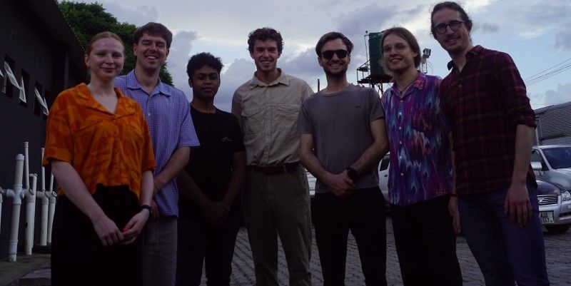 A group of PhD students in Zambia smiling at the camera.