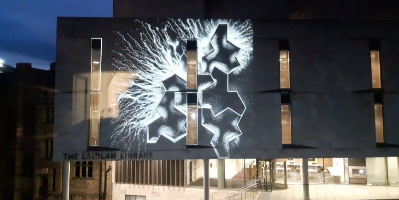 A graphic white light display projected onto the Laidlaw Library.