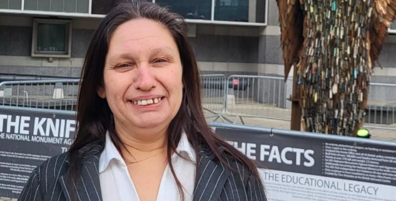 Anti knife crime campaigner Sarah Lloyd is stood in front of the Knife Angel at Leeds docks.