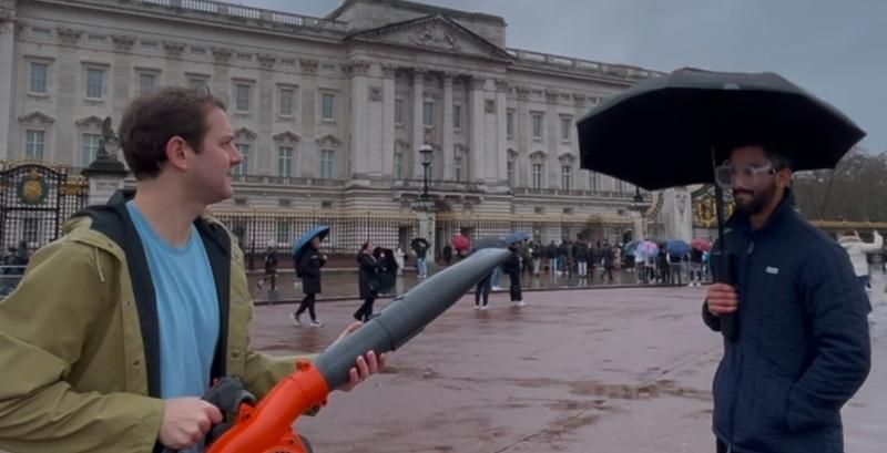 Reid points a powerful leaf blower at Trib Gosain to test out the Gilley Umbrella Trib is holding.