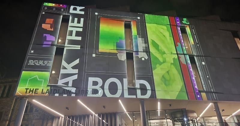 Words and images are projected on to the Laidlaw Library.